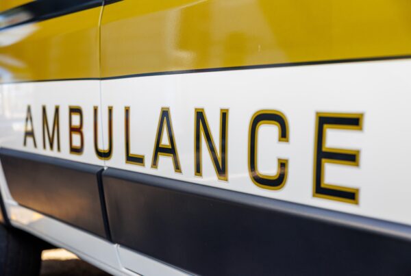 The side of an Oxford Health Systems ambulance, with the word 'Ambulance' on the side.