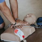 Man performing CPR on a practice dummy
