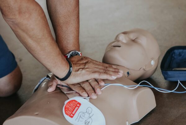 Man performing CPR on a practice dummy