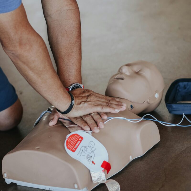 Man performing CPR on a practice dummy