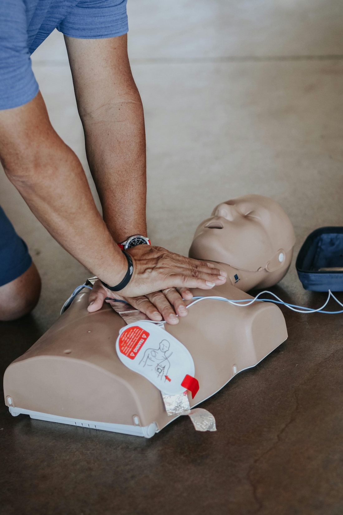 Man performing CPR on a practice dummy