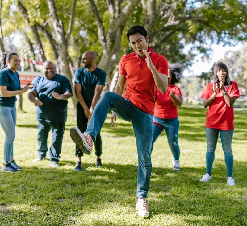 Adults in park being active